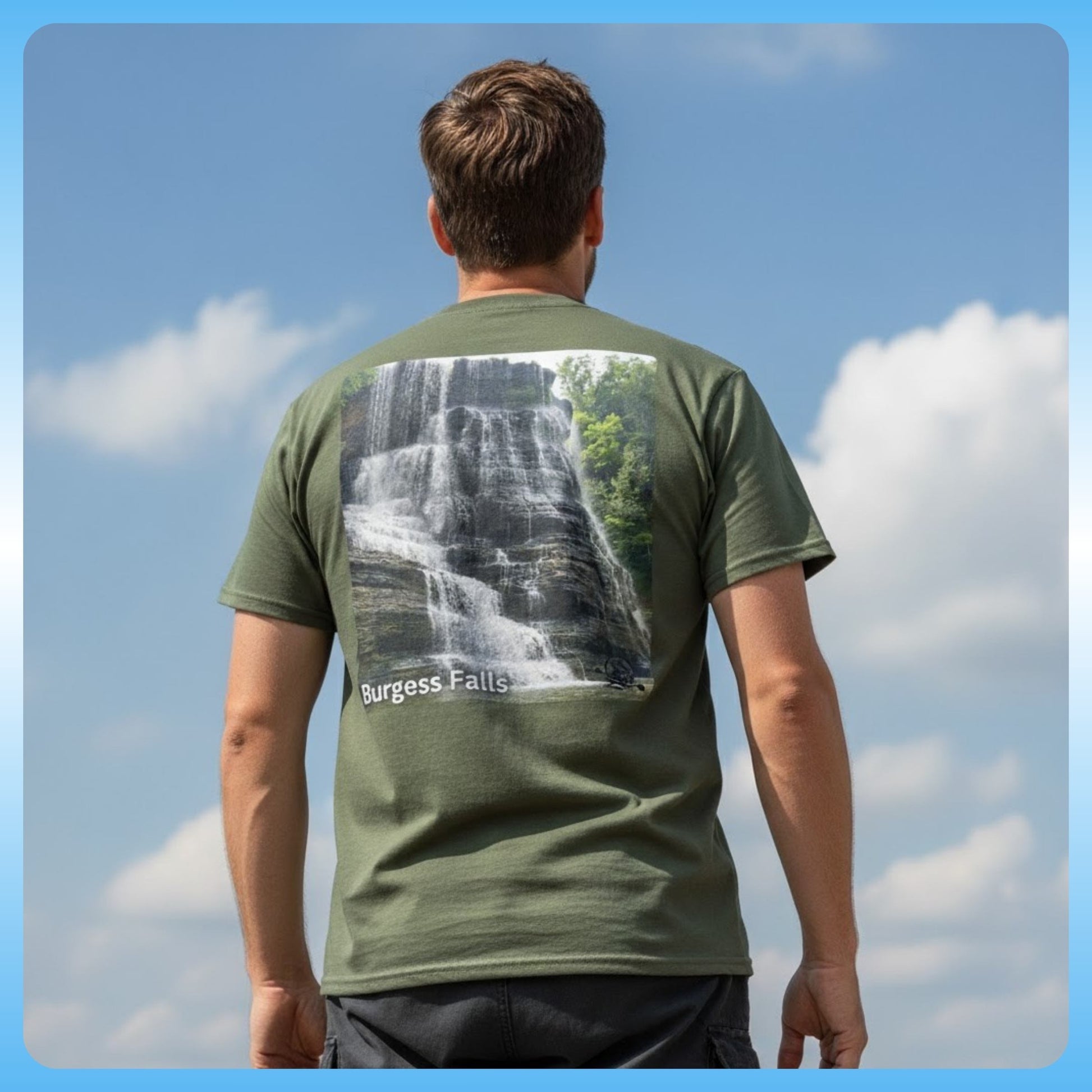 Person wearing a military green t-shirt with a waterfall graphic and 'Burgess Falls' text, standing against a blue sky.