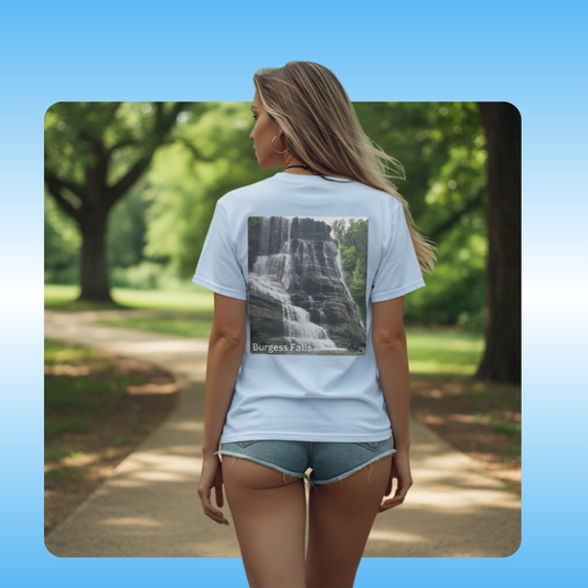Burgess Falls | Paddle Frogs™ T-shirts worn by model in light blue by Megan | Woman wearing a Burgess Falls Sparta TN t-shirt with a waterfall graphic and 'Burgess Falls' text, standing in a park.