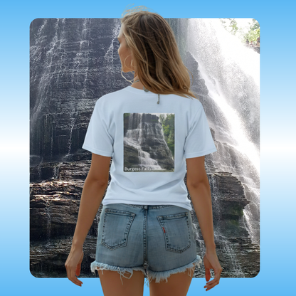 Burgess Falls | Paddle Frogs™ T-shirts worn  in light blue by Megan | Person wearing a light blue t-shirt with a waterfall design, standing in front of a real waterfall.