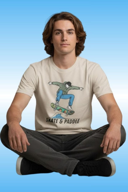 Man sitting crisscross applesauce wearing the Chlorophyll Cruiser Skate & Paddle 100% cotton tee by Paddle Frogs outdoor gear