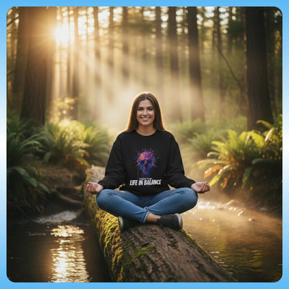 Crisscross applesauce at sunset on a  log wearing the Black drip paint skull sweatshirt by Paddle Frogs Outdoor Gear