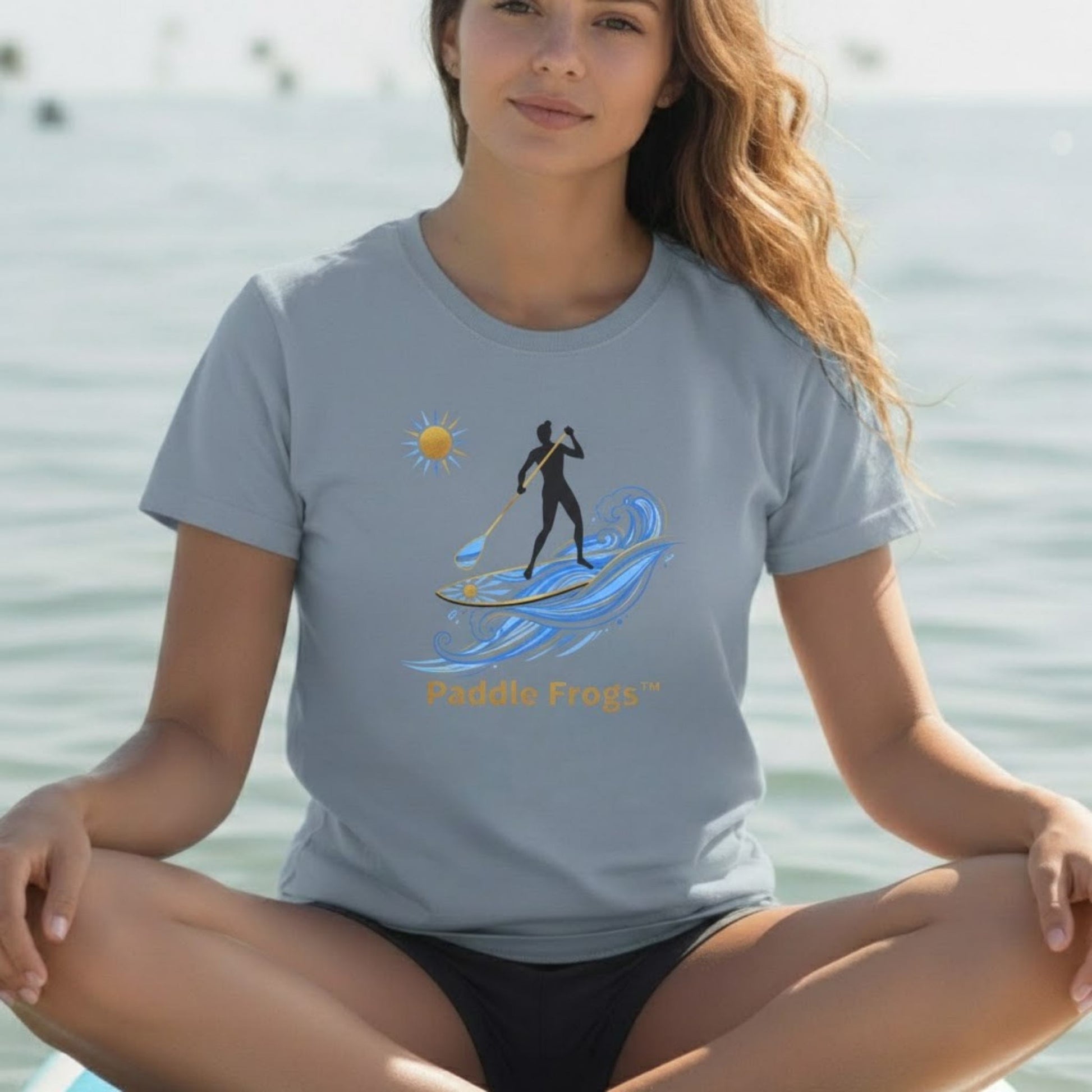 Crisscross applesauce on the Divine Escape paddle board wearing the "Sun Stoke" High-Quality Stand-Up Paddleboard T-Shirt – Premium Ring-Spun Cotton SUP Tee