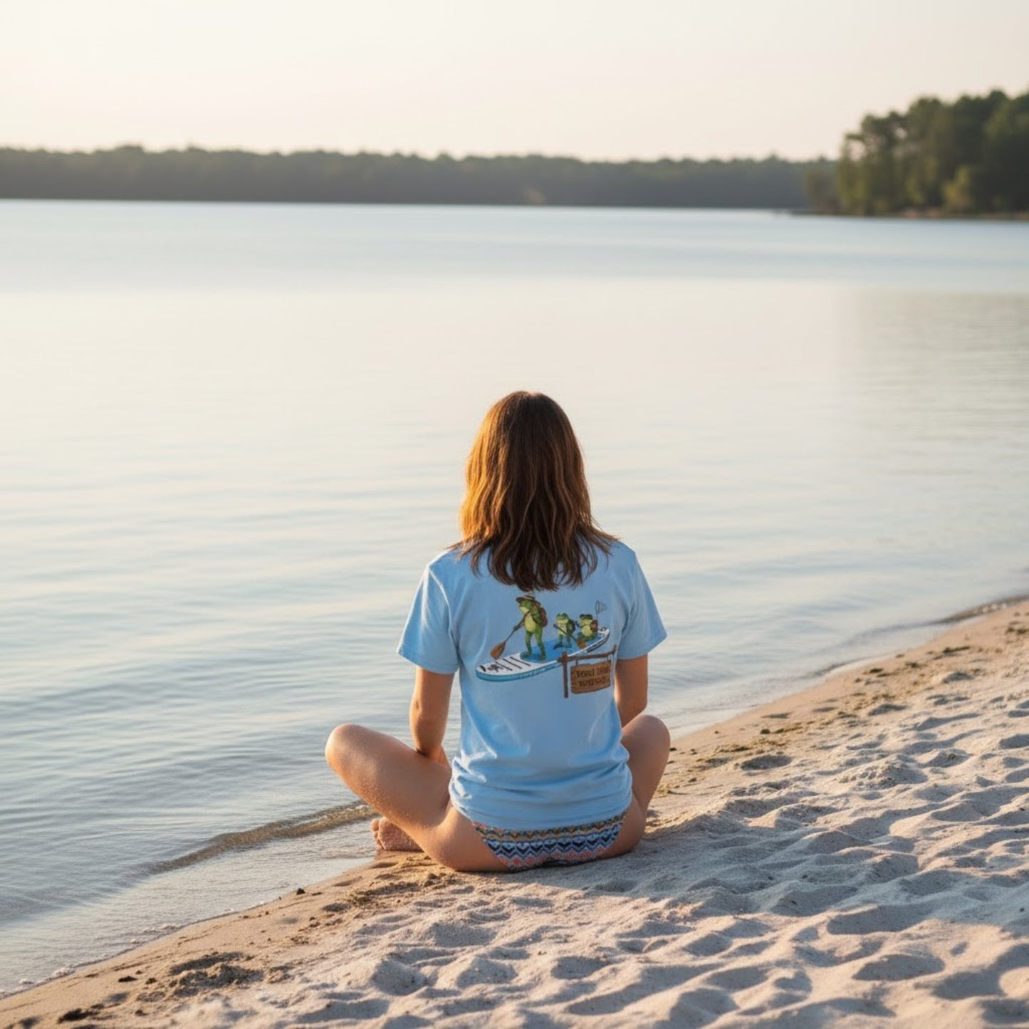 Divine Escape Paddle Frogs Adventure Tee - Light blue sitting crisscross applesauce at the river beach Kingston Tennessee