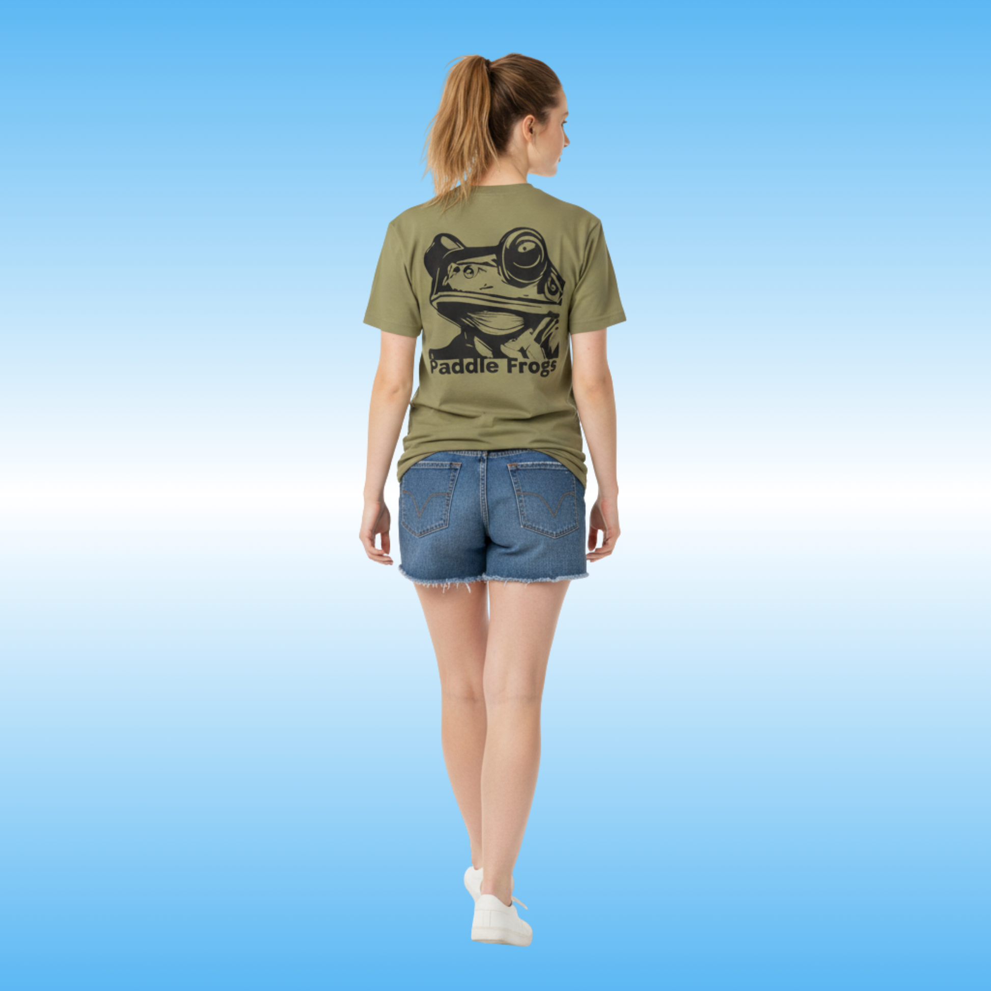 Earthy Tee | Paddle Frogs™ Person wearing a green t-shirt with a frog graphic and 'Paddle Frog' text on a blue background