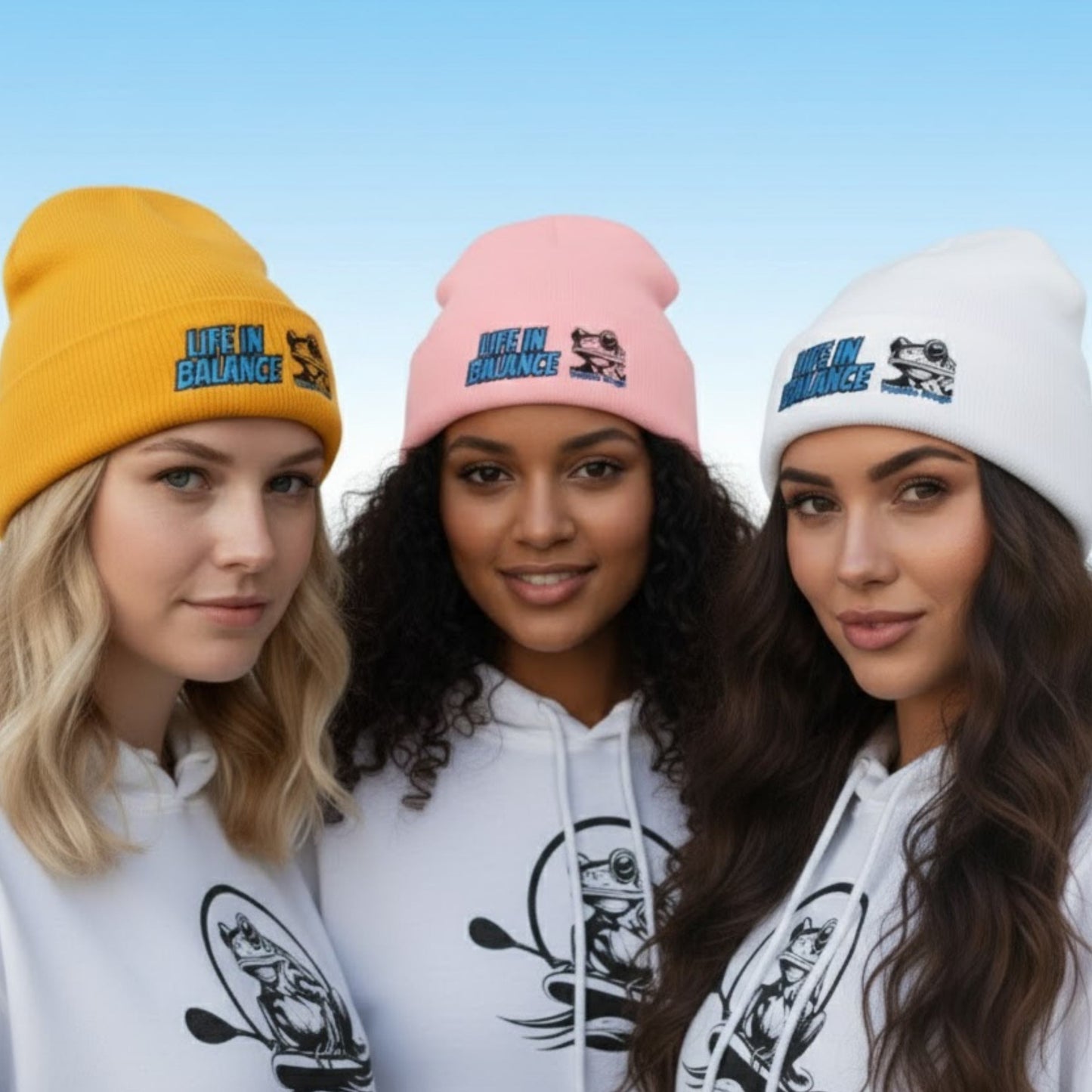 Fall seasonal threads 3 ladies - Life in Balance | The Wanderer's Anchor: Cuffed Beanie - Three women wearing beanies and matching hoodies with a blue sky background