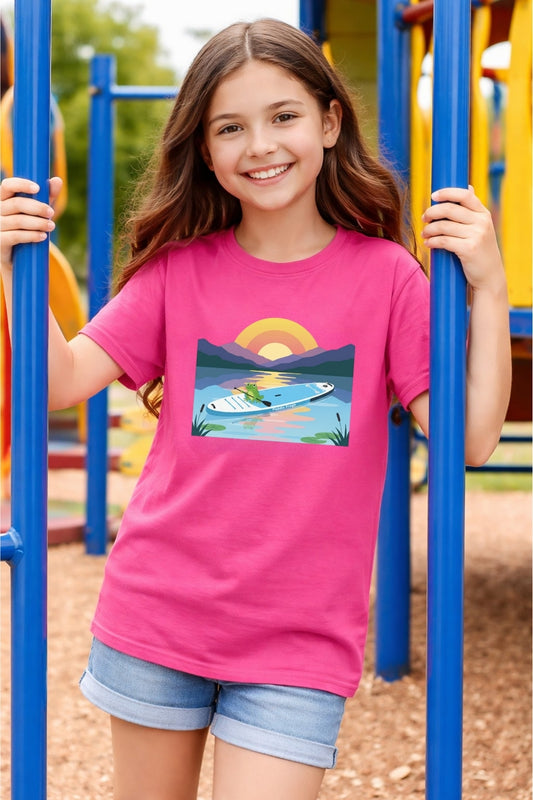 Girl wearing Paddle Frogs T-Shirt 'Frog Days' in Heliconia Pink color | Divine Escape Paddleboard at sunrise Tee
