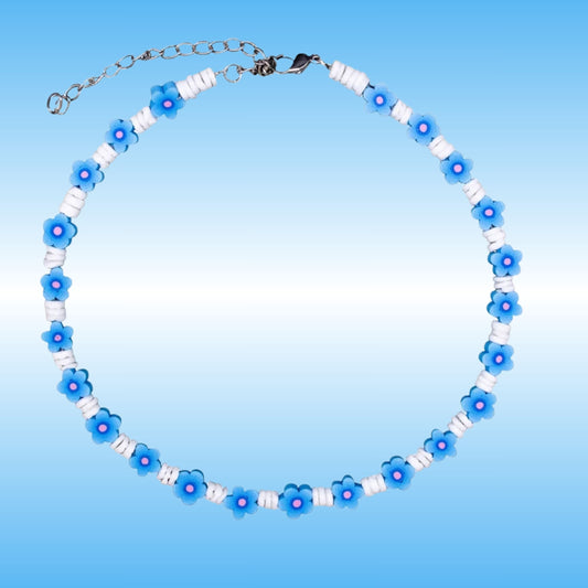 A beaded necklace featuring alternating light blue flower beads with white centers and white cylindrical spacer beads, completed with a silver-tone clasp and extender chain, set against a light blue gradient background.