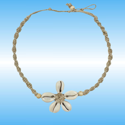 A handmade braided hemp necklace with a central flower charm made from five cowrie shells, set against a blue gradient background.