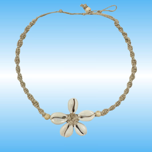 A handmade braided hemp necklace with a central flower charm made from five cowrie shells, set against a blue gradient background.