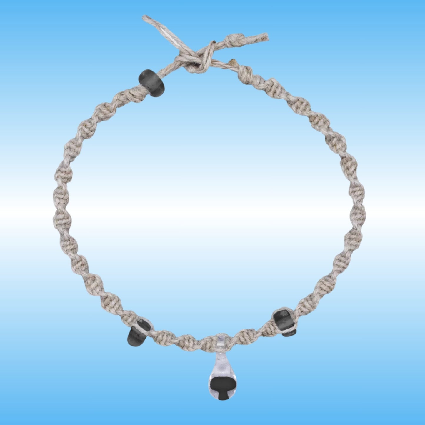 Hand-Braided Hemp Mushroom Anklet or Bracelet with a glass center piece with a black mushroom inside.