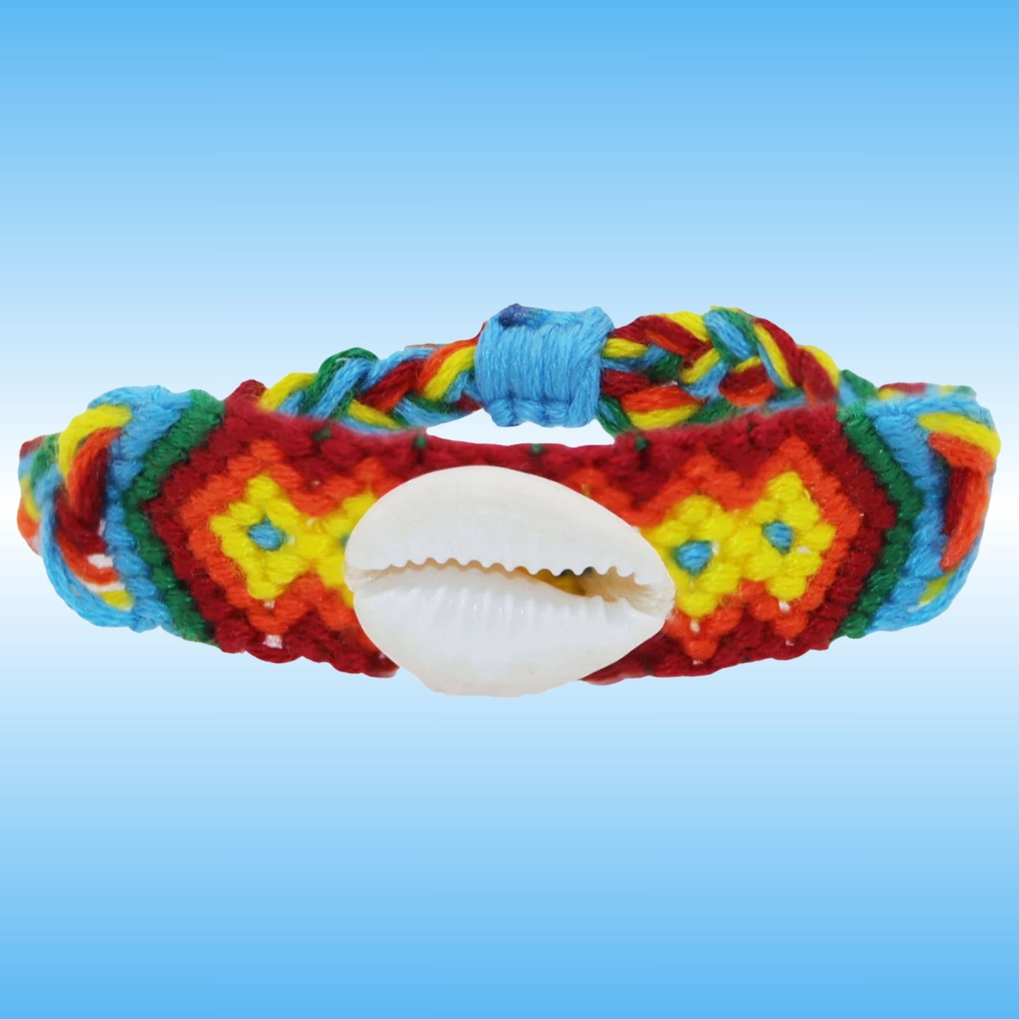 A colorful braided friendship bracelet with a white cowrie shell in the center, set against a light blue gradient background.