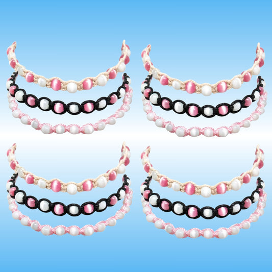 Four matching beaded headbands arranged in a 2x2 grid on a light blue gradient background. Each headband features three rows of beads: a top row of white pearl-like beads, a middle row of alternating pink and white beads, and a bottom row of alternating black and pink beads.