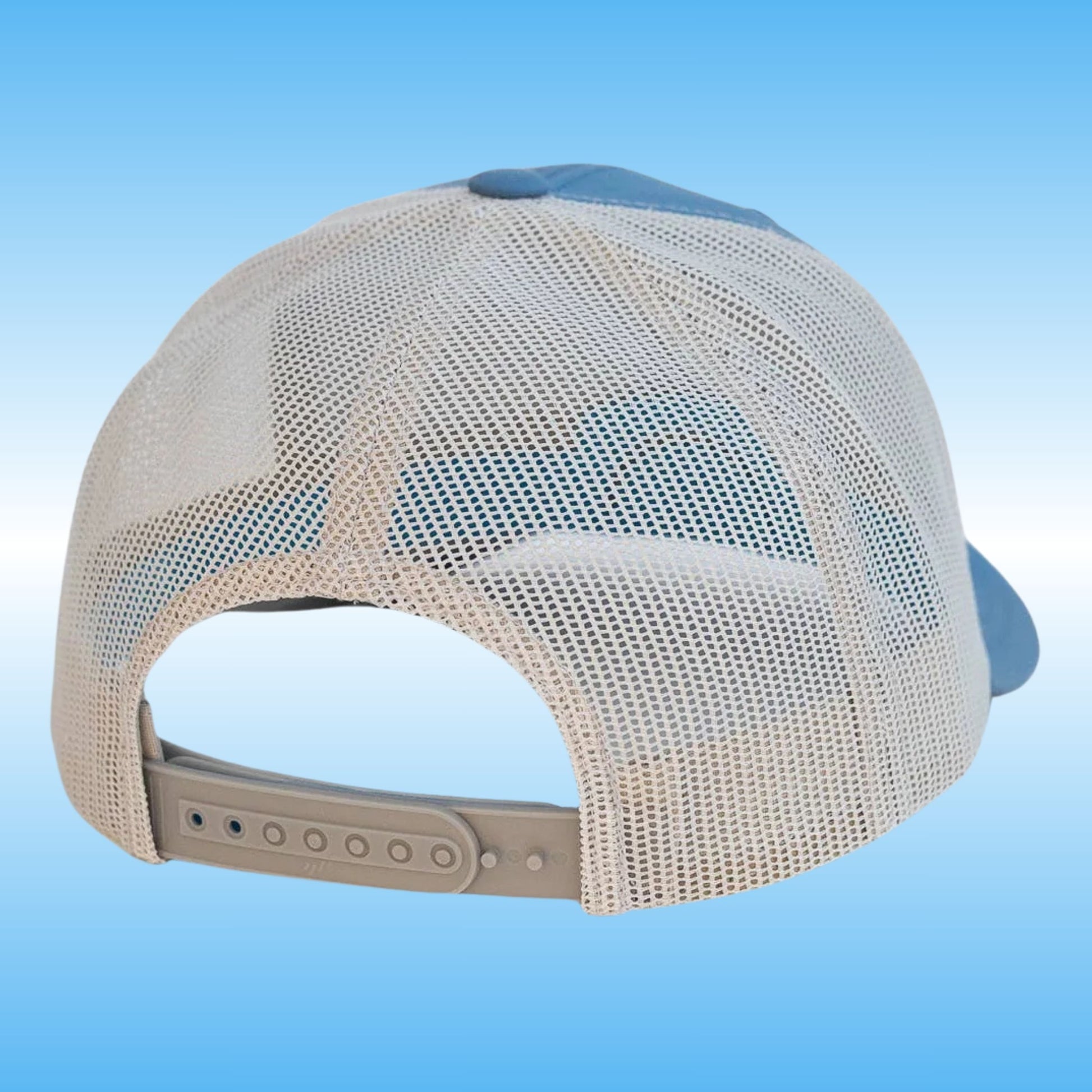 A silver mesh back baseball cap shown from the rear, featuring a light gray adjustable strap and a blue-gray fabric crown top, set against a blue gradient background.
