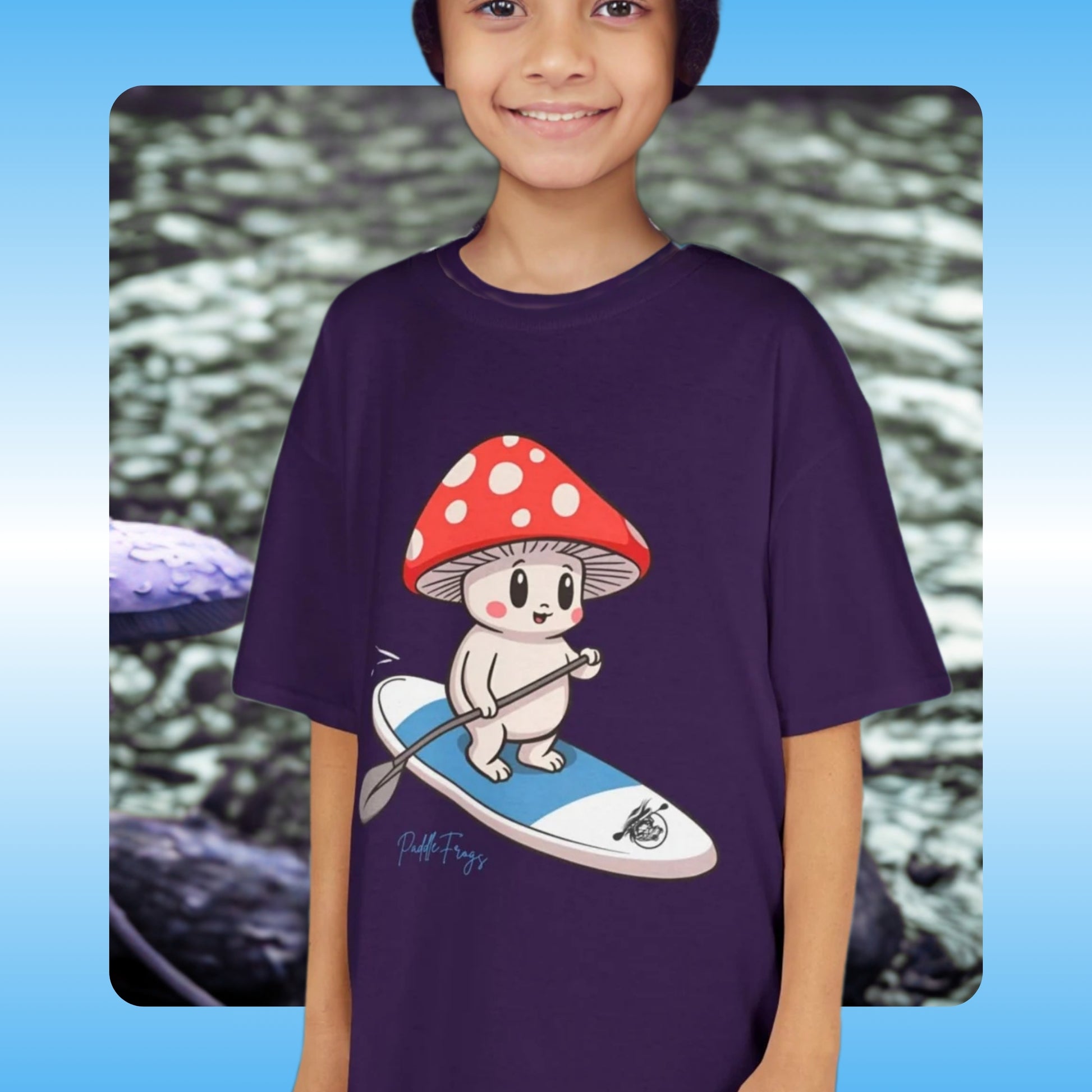 Kids Tee - Child wearing a purple t-shirt with a cartoon mushroom character on a blue and white paddle board = Paddle Frogs
