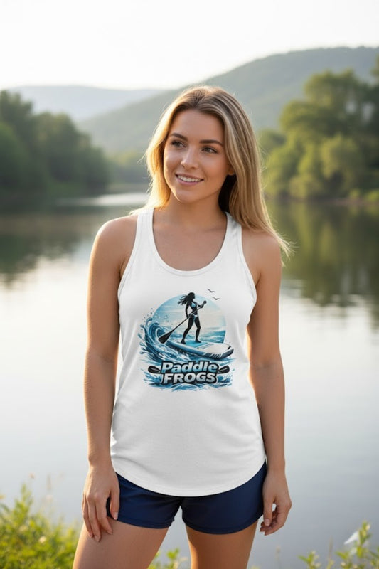 Woman wearing a white tank top with a paddleboard design by a lake