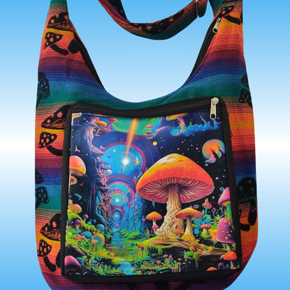 A colorful shoulder bag with a rainbow-striped border and a large front pocket featuring a vibrant psychedelic mushroom forest illustration, set against a light blue gradient background.