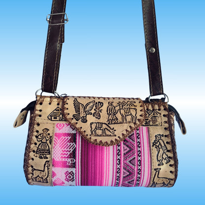 A handmade crossbody bag with a tan woven body featuring black embroidered motifs, a vibrant pink and purple striped textile panel, and dark brown leather straps.