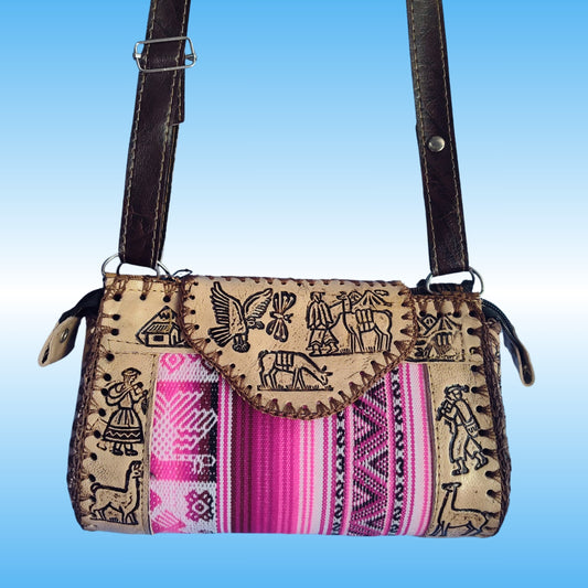 A handmade crossbody bag with a tan woven body featuring black embroidered motifs, a vibrant pink and purple striped textile panel, and dark brown leather straps.
