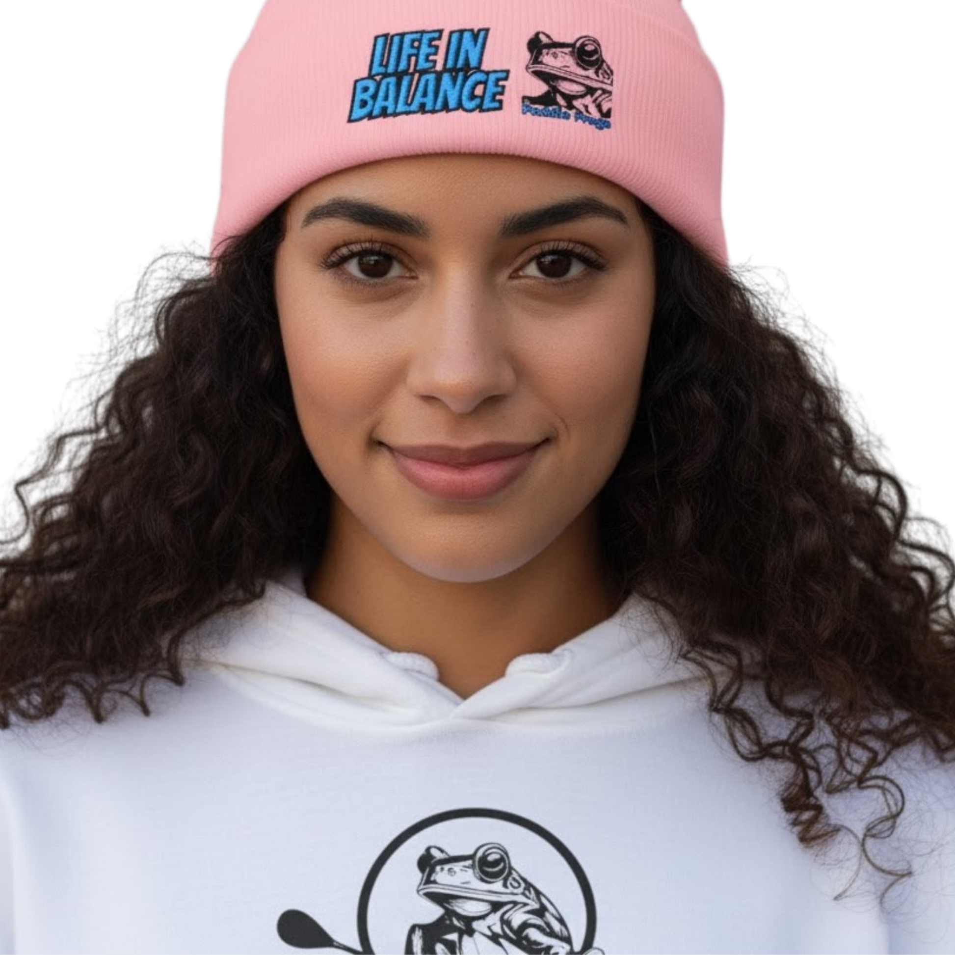 Person wearing a pink beanie and white hoodie with frog designs on a white background Life in Balance | The Wanderer's Anchor: Cuffed Beanie in Pink on a transparent background