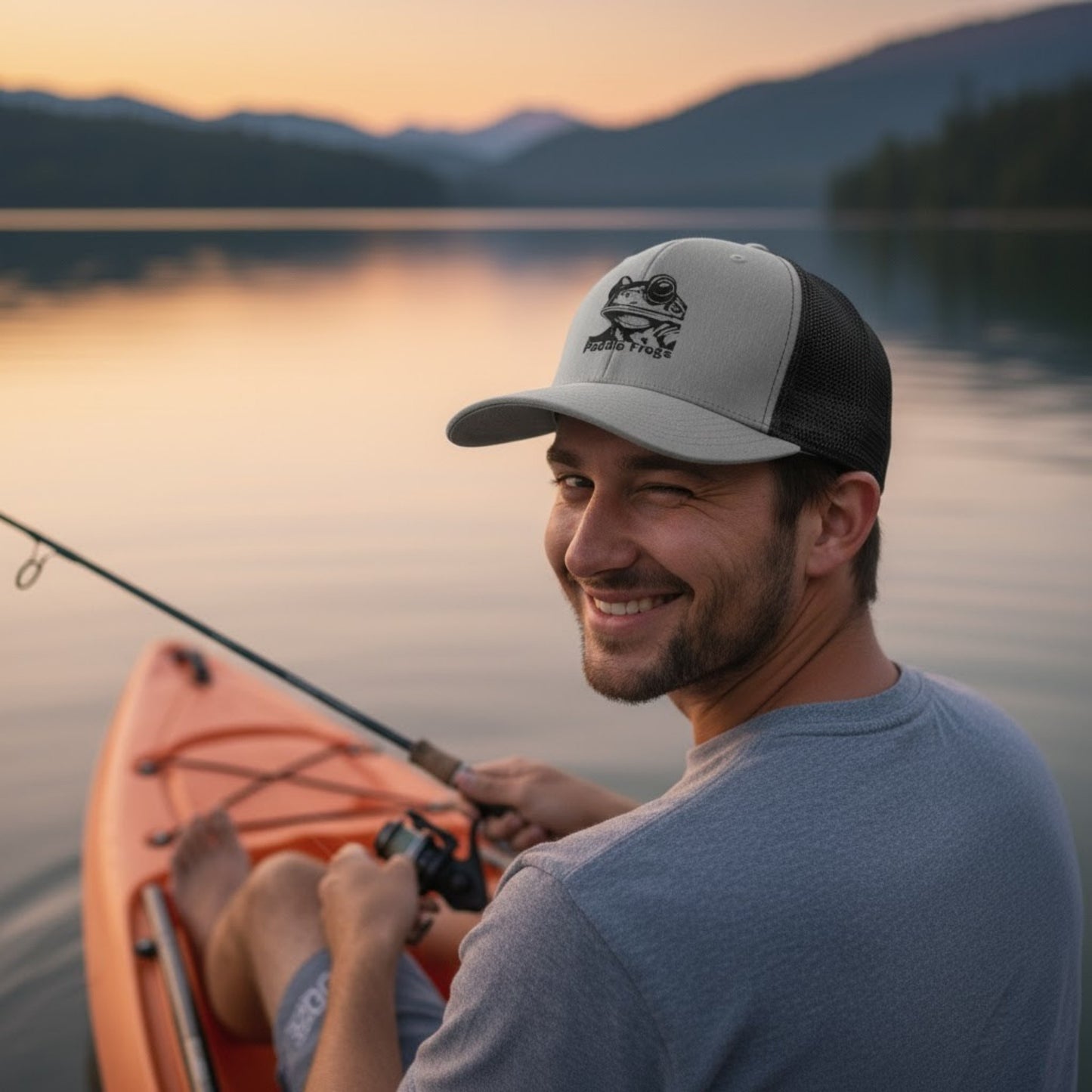 Male  fishing winking and wearing Paddle Frogs™ Snapback Cap heather grey and black vented mesh