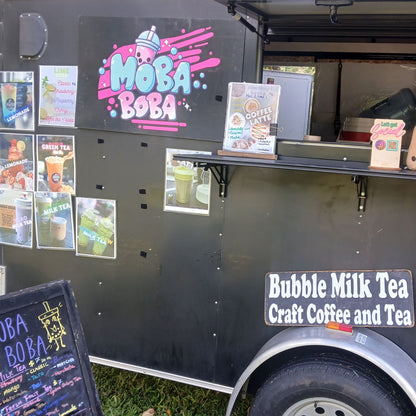 Moba Boba serving coffee and bubble milk tea. The side displays menu posters, a service window, and a sign reading 'Bubble Milk Tea Craft Coffee and Tea'. Sundays at the Paddle Frogs Sunday Market.