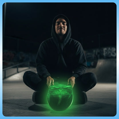 Person in dark hoodie sitting with Molphunktzer 2nd Edition | 8.75 Skateboard Deck | Paddle Frogs™ glow in the dark