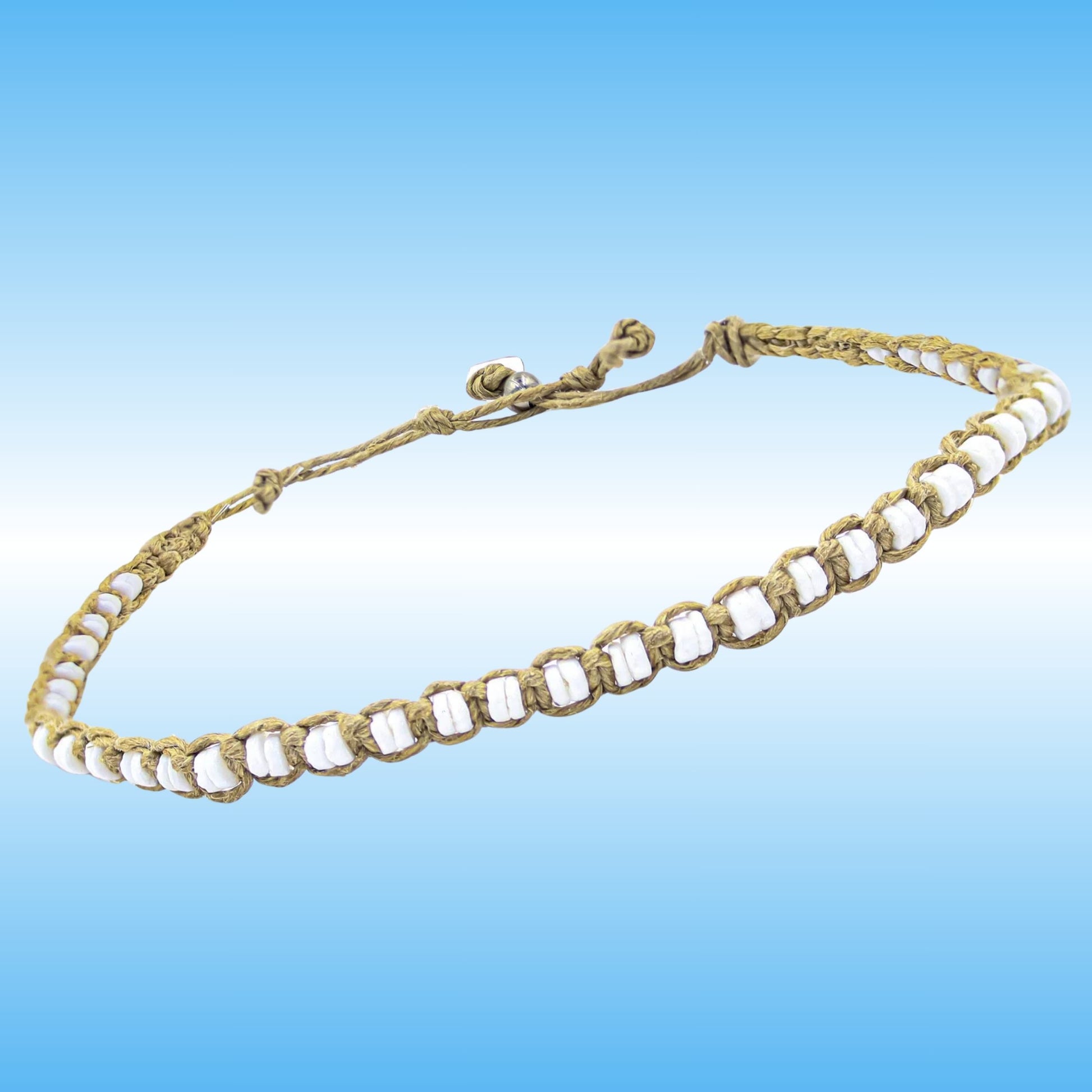 A handmade braided cord anklet with white shell beads, displayed against a blue gradient background.