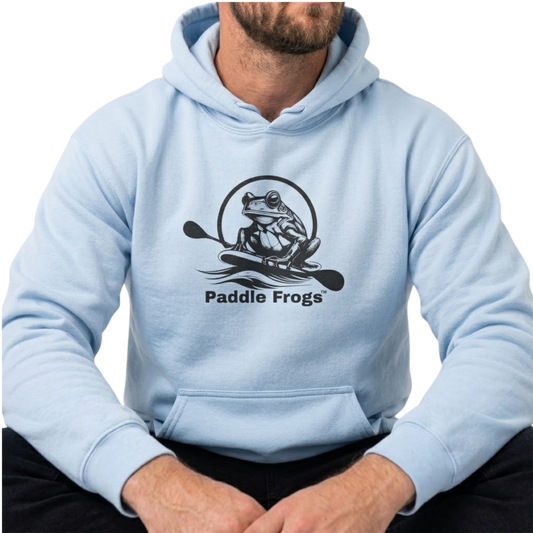 A man wearing a light blue hoodie with a black graphic of a frog in a kayak and the text 'Paddle Frogs' on the chest, shown against a plain white background.