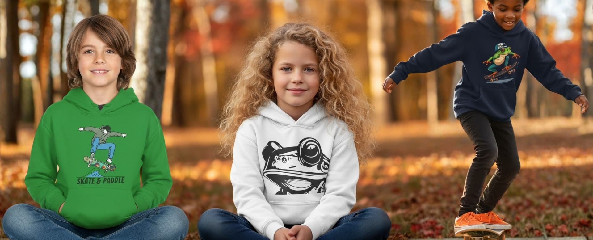 Three children wearing hoodies with skate and paddle graphics in a forest setting. Paddle Frogs Kids Hoodie