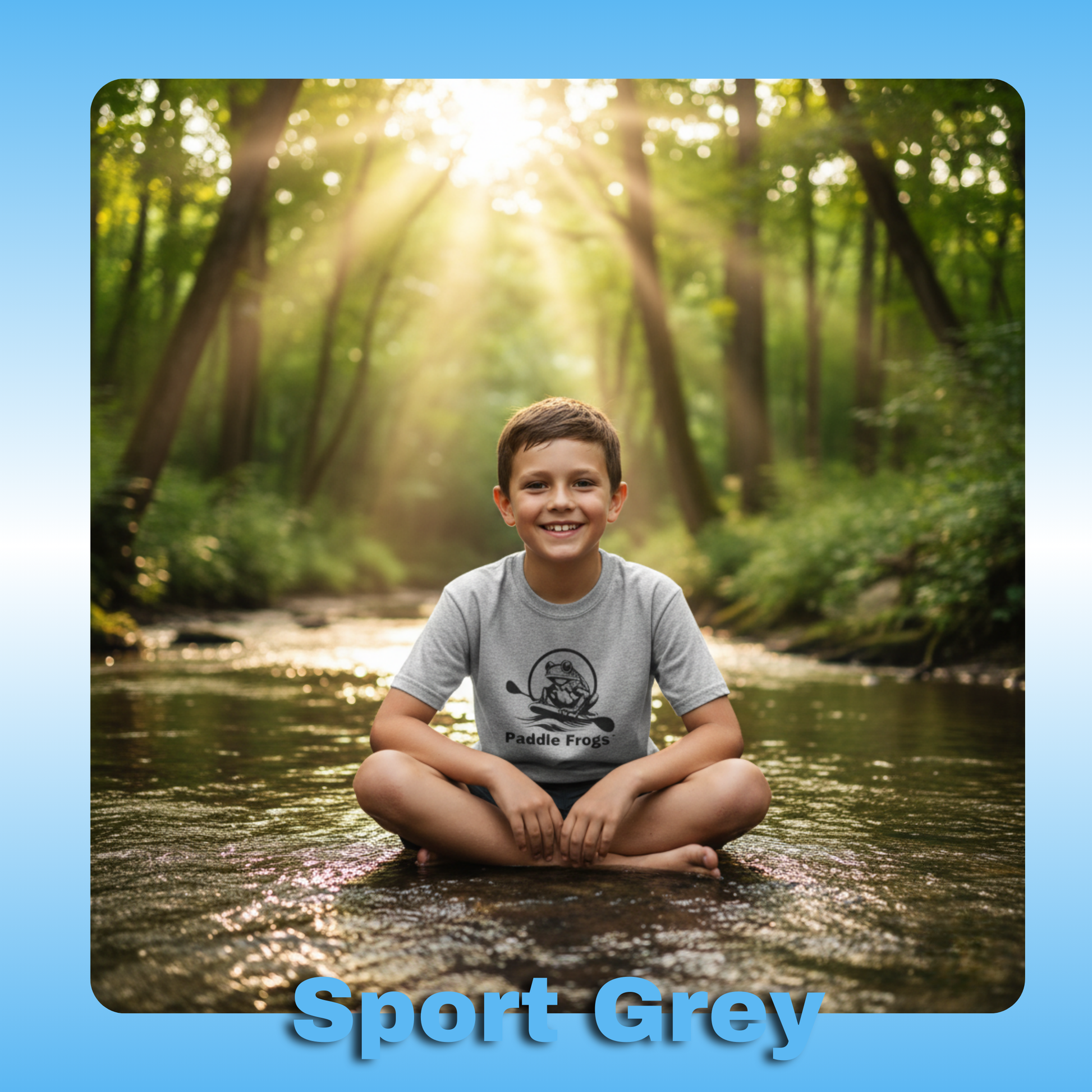 Paddle Frogs Kids T-Shirts | Sport Grey with an 8 year old boy in the creek sitting crisscross applesauce | Child sitting in a forest stream wearing a gray t-shirt with a logo.