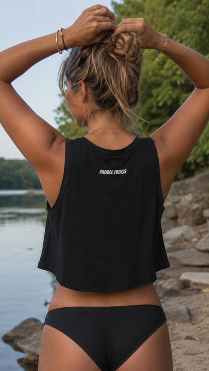 a lady at the river modeling a Paddle Frogs paddleboarding crop top. It is black and cute.