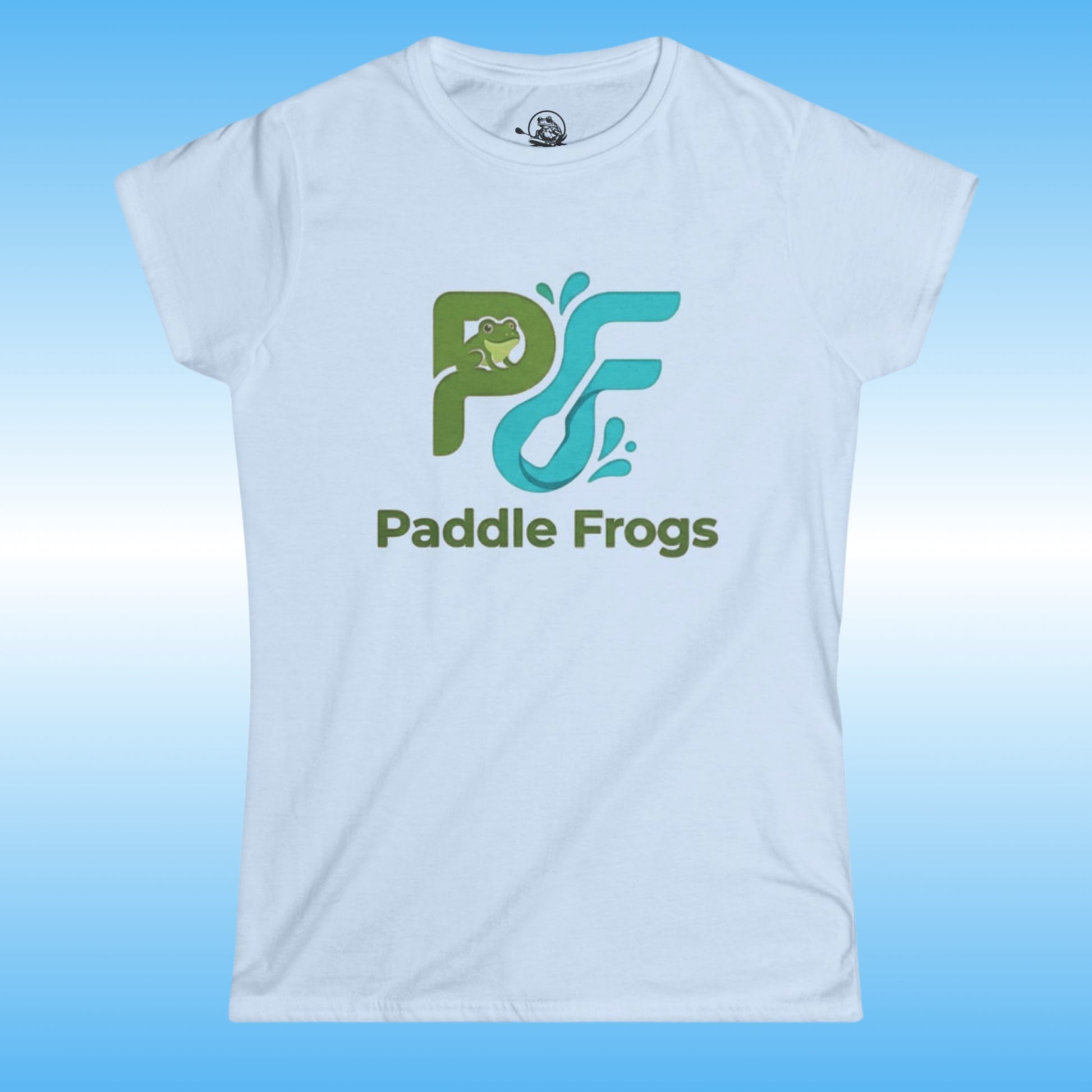 A light blue women's short-sleeve t-shirt with a 'Paddle Frogs' logo printed on the chest, displayed against a blue gradient background.