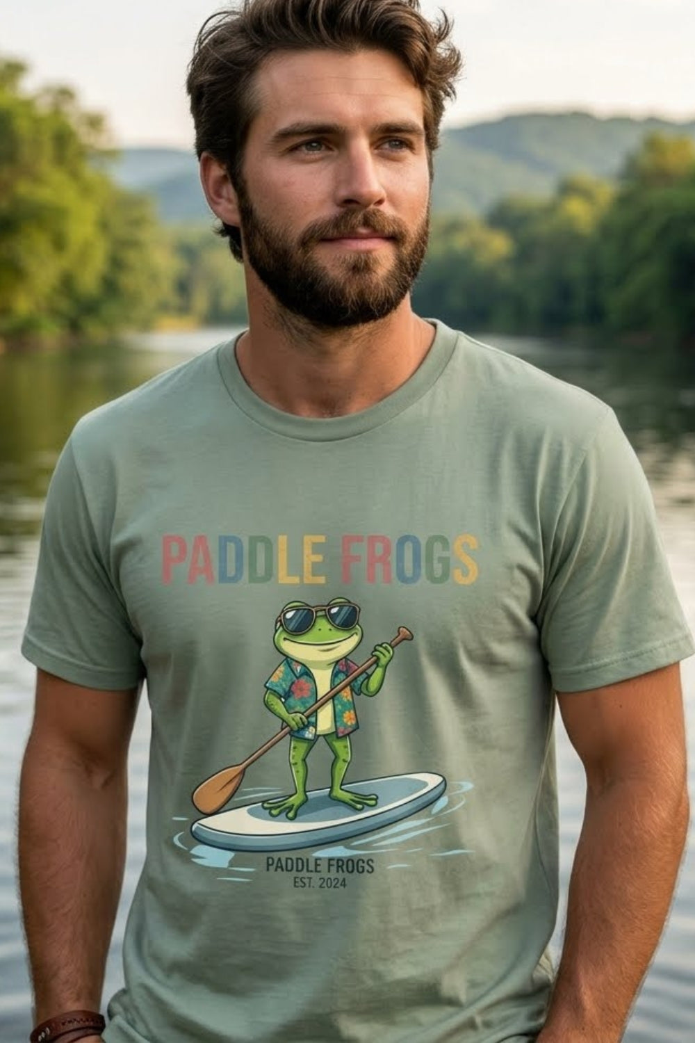 A man wearing the Paddling Frog Tee by Paddle Frogs Outdoor Gear brand a frog paddling in glasses and a vacation Hawaiian shirt Sage Green tee
