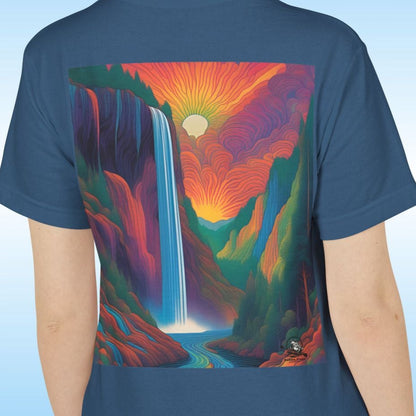 Person wearing a blue t-shirt with a colorful Pop Art mountain and waterfall design on the back against a light blue background