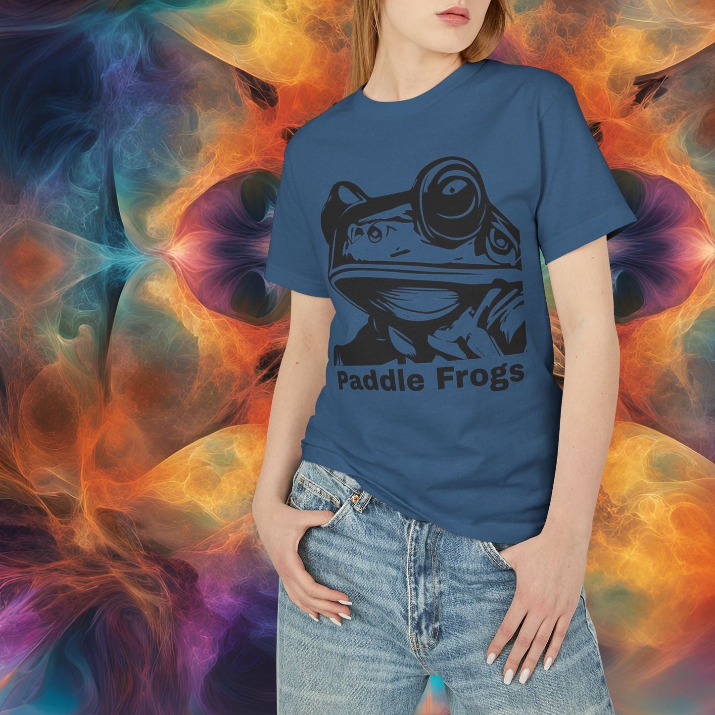 Person wearing a blue t-shirt with a graphic design in front of a colorful abstract background Faded Navy Blue Olive Chaos vs Sea Queen T-shirt | Paddle Frogs Skater and paddle boarder shirt