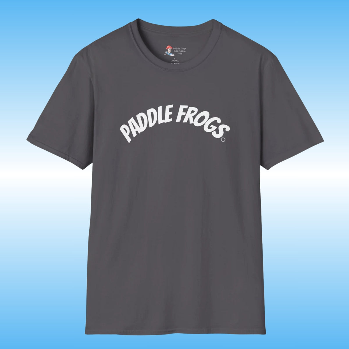 A dark gray 100% cotton, soft crewneck t-shirt featuring the words 'PADDLE FROGS' printed in white arched text across the chest, displayed against a blue gradient background.
