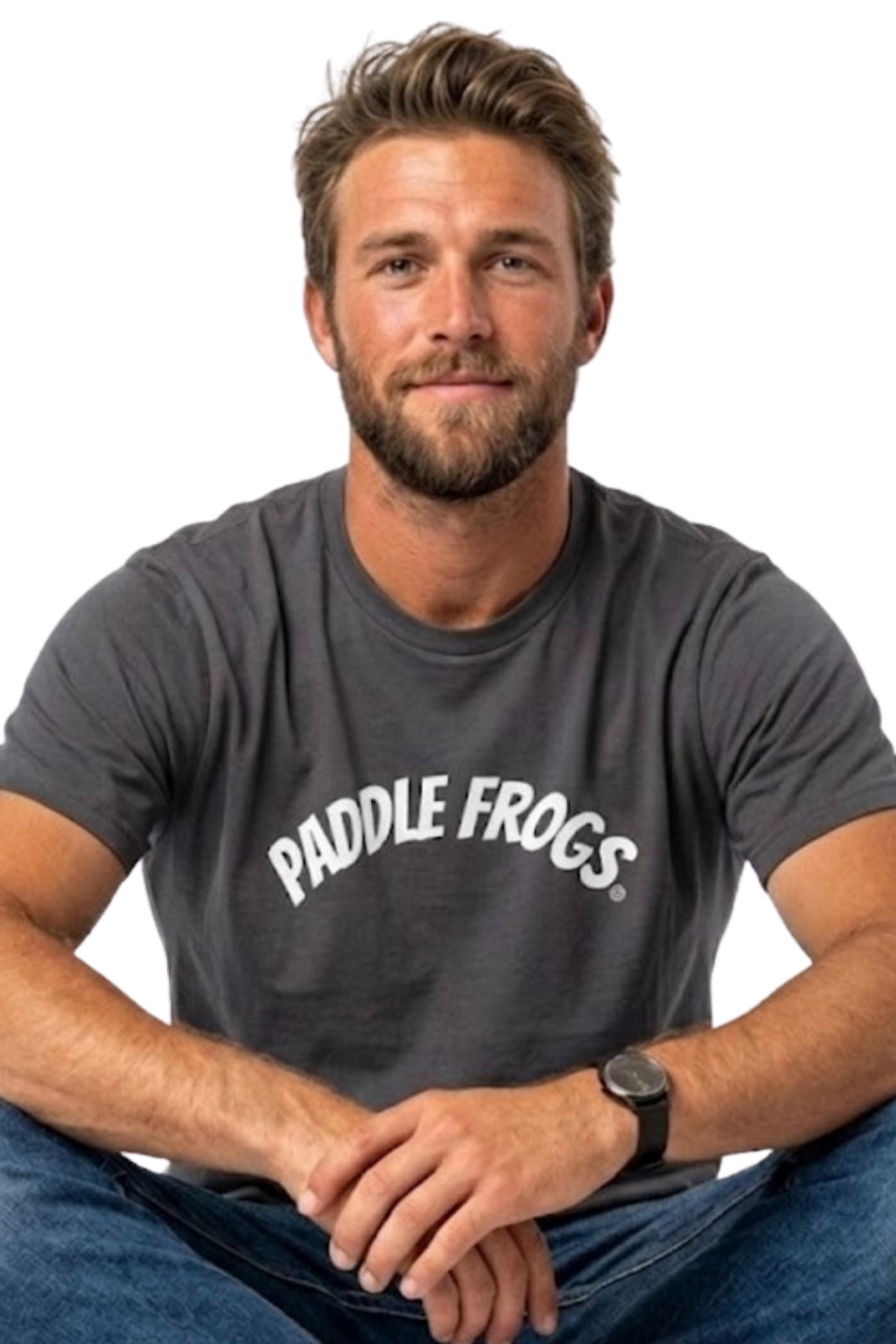 A man wearing a charcoal gray soft cotton t-shirt with 'PADDLE FROGS' printed in white across the chest, paired with blue jeans, sitting against transparent background