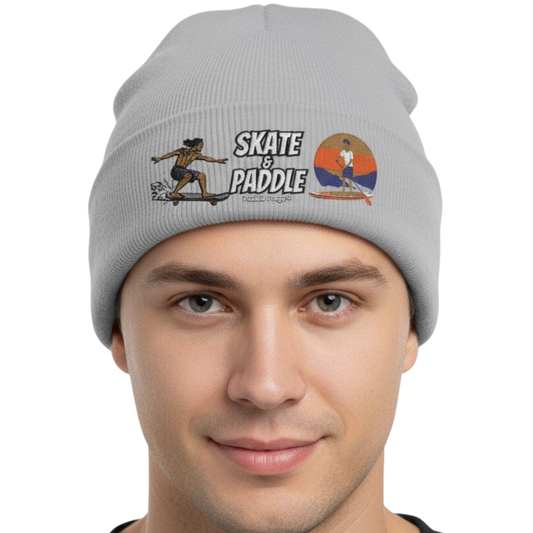 Rhythmic Life: The Skate & Paddle Beanie by Paddle Frogs™ Gray color on a transparent background Gray beanie with 'Skate & Paddle' design worn by a person on a white background