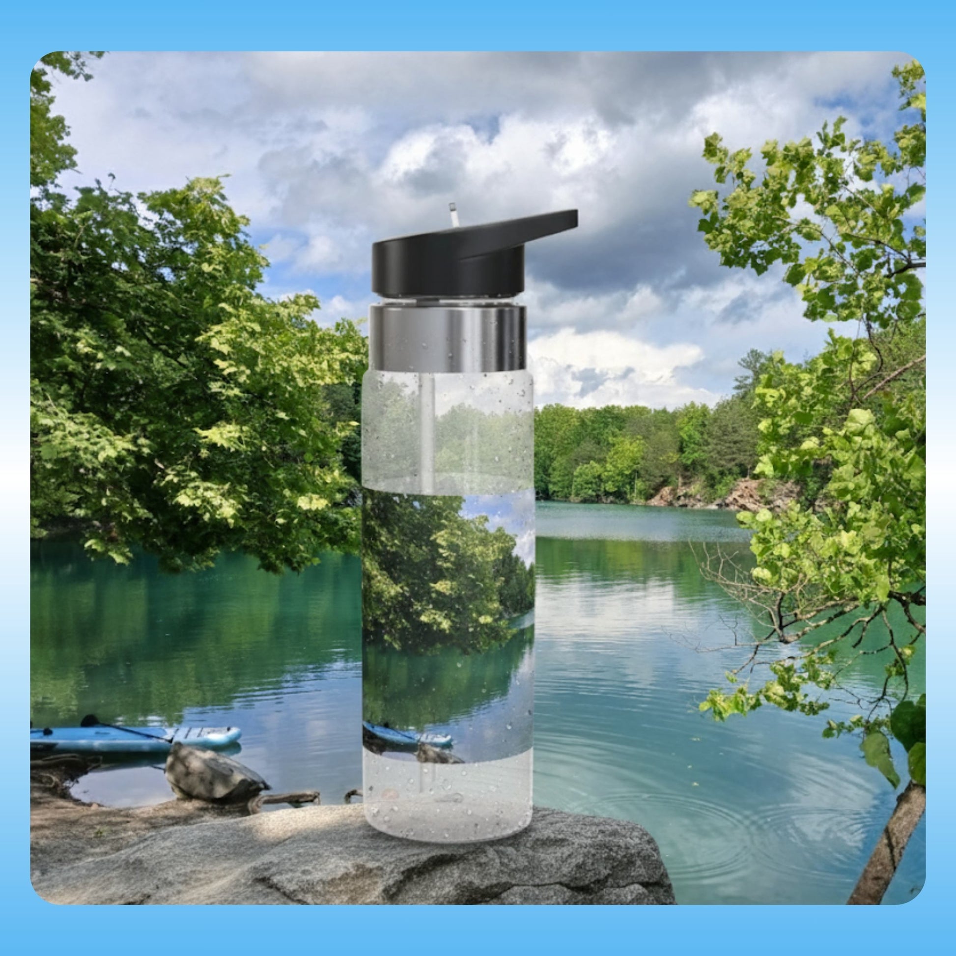 Secret City Quarry in Tennessee with the Divine Escape paddle board Clear water bottle with black cap on a rock by a lake with trees
