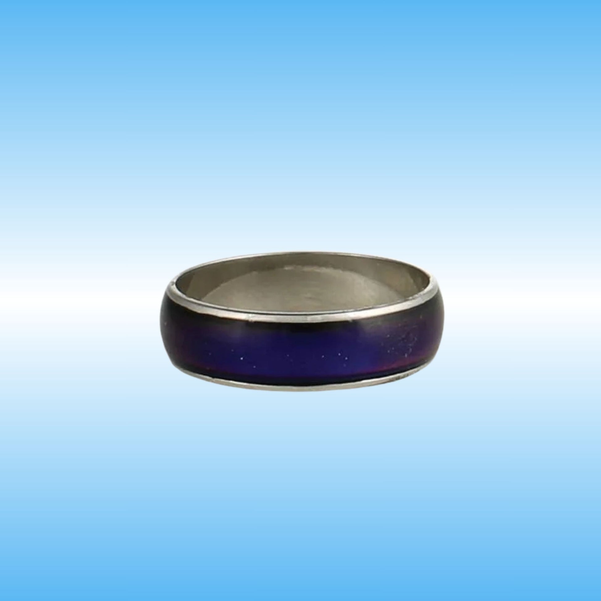 A silver-toned metal ring with a dark purple inlay, shown against a blue gradient background.