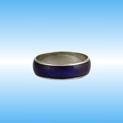 A silver-toned metal ring with a dark purple inlay, shown against a blue gradient background.