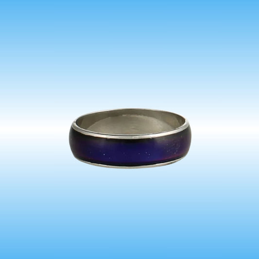 A silver-toned metal ring with a dark purple inlay, shown against a blue gradient background.