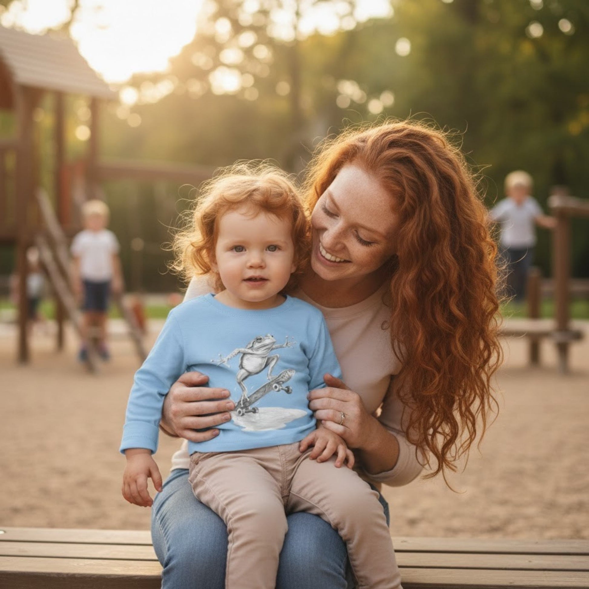 Sitting on moms lap at the playground light blue Skate Jam Long Sleeve Tee: Ollie Frog Kids Shirt | Paddle Frogs™