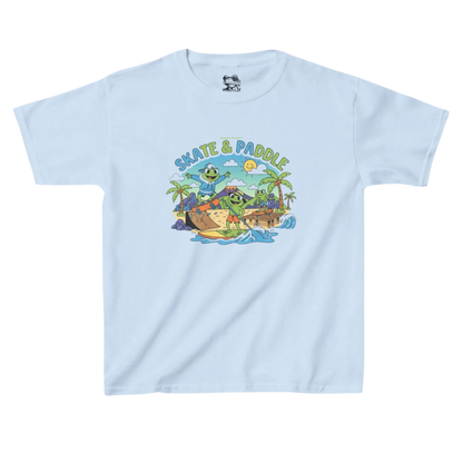 Skate & Paddle Paddle Frogs Kids | Light blue t-shirt with a graphic design of a beach scene, volcano, paddle board, skateboarding and 'Skate & Paddle' text on a white background.