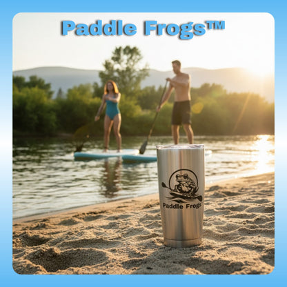 Paddle Frogs™ Stainless steel tumbler with 'Paddle Frogs' logo on a beach with people paddleboarding in the background.