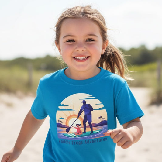 girl running wearing a Sapphire Blue T-Shirt with text Paddle Frogs Adventures and a sunrise paddleboarding graphic