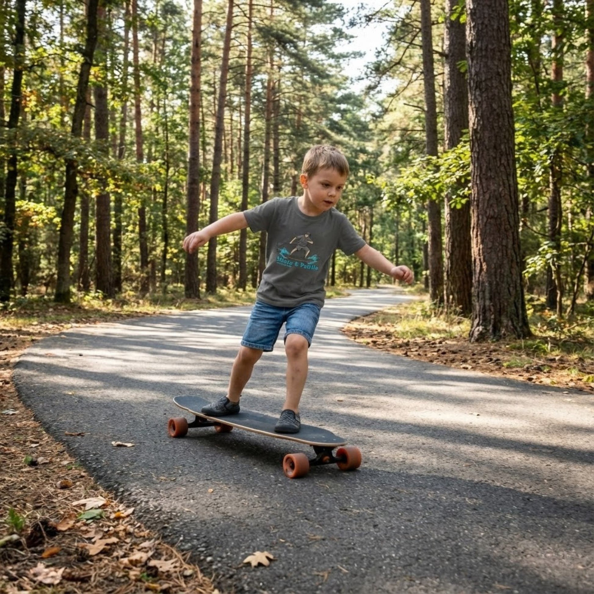 The Coastal Hop: Tiny Ripples & Pavement Waves Toddler "Skate & Paddle Frogs™ skating a longboard on asphalt through the woods