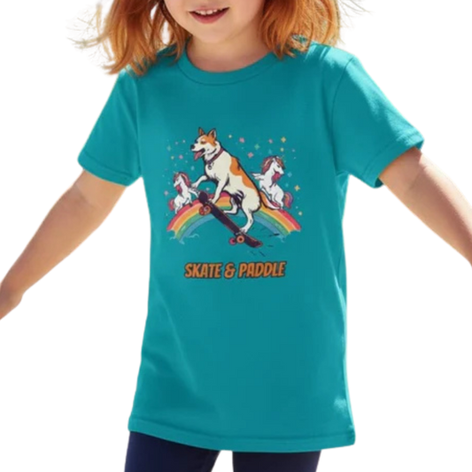 Child wearing a teal t-shirt with a graphic design of a dog and unicorn on a rainbow, with 'Skate & Paddle' text on a transparent background