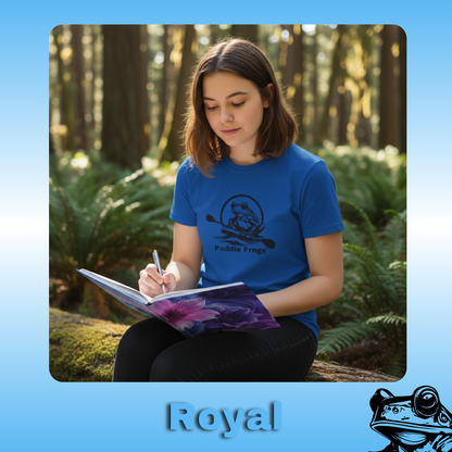 The Original Paddle Boarding T-Shirt | Paddle Frogs™ Royal (blue) Tee | Young Lady Teen Person wearing a blue shirt with a logo, sitting in a forest and writing in a notebook.