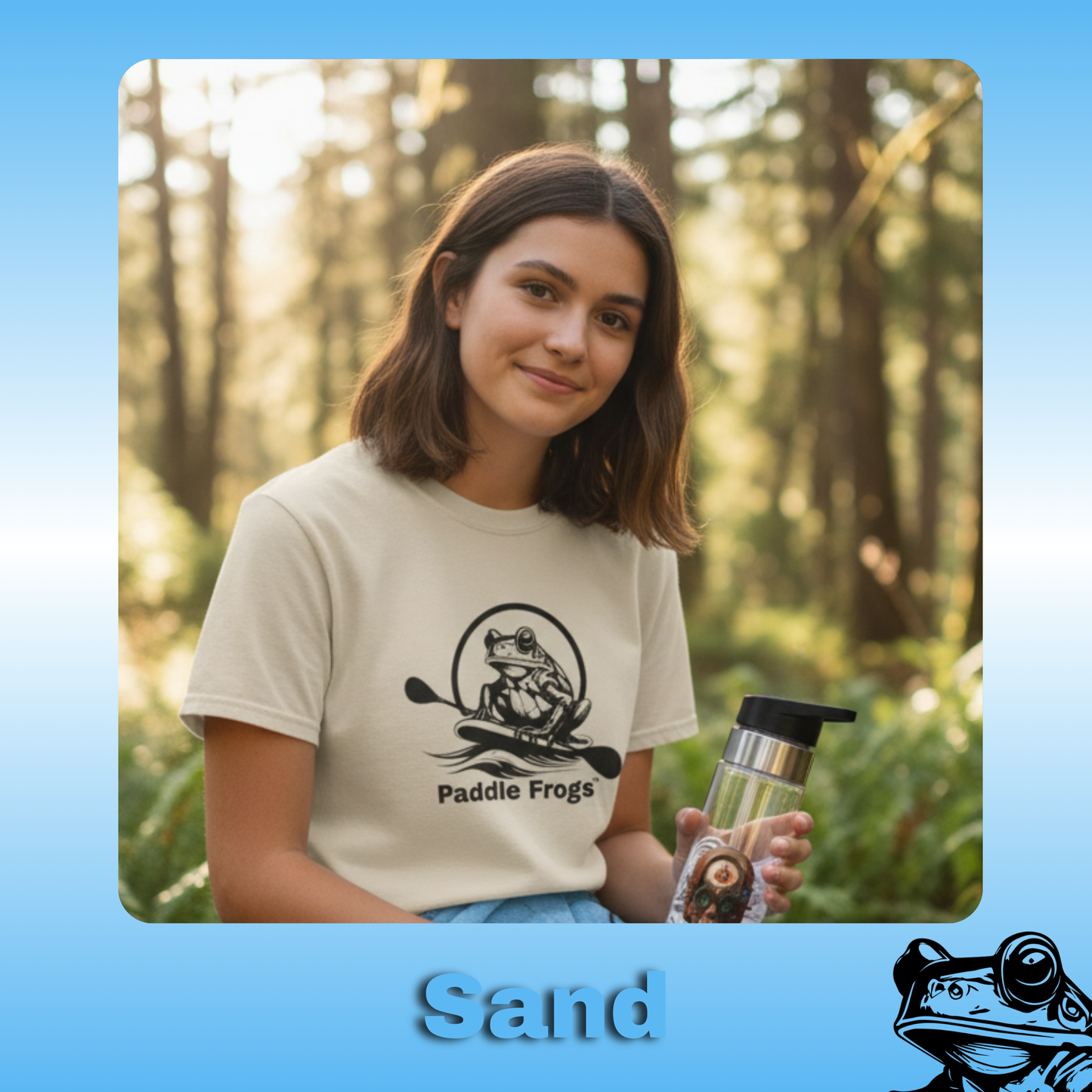 The Original Paddle Boarding T-Shirt | Paddle Frogs™ Sand color Tee  | Woman in a forest holding a water bottle with 'Paddle Frogs' branding